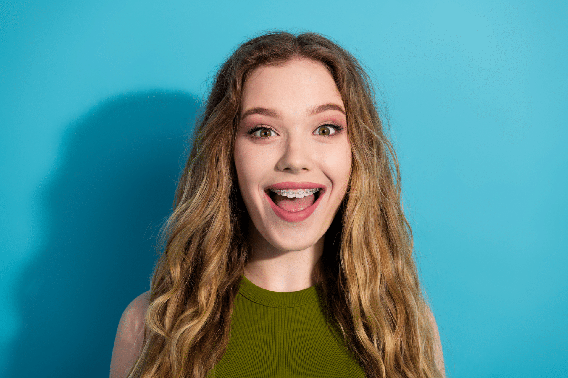 Adult smiling with braces before orthodontic treatment planning in Downers Grove, IL